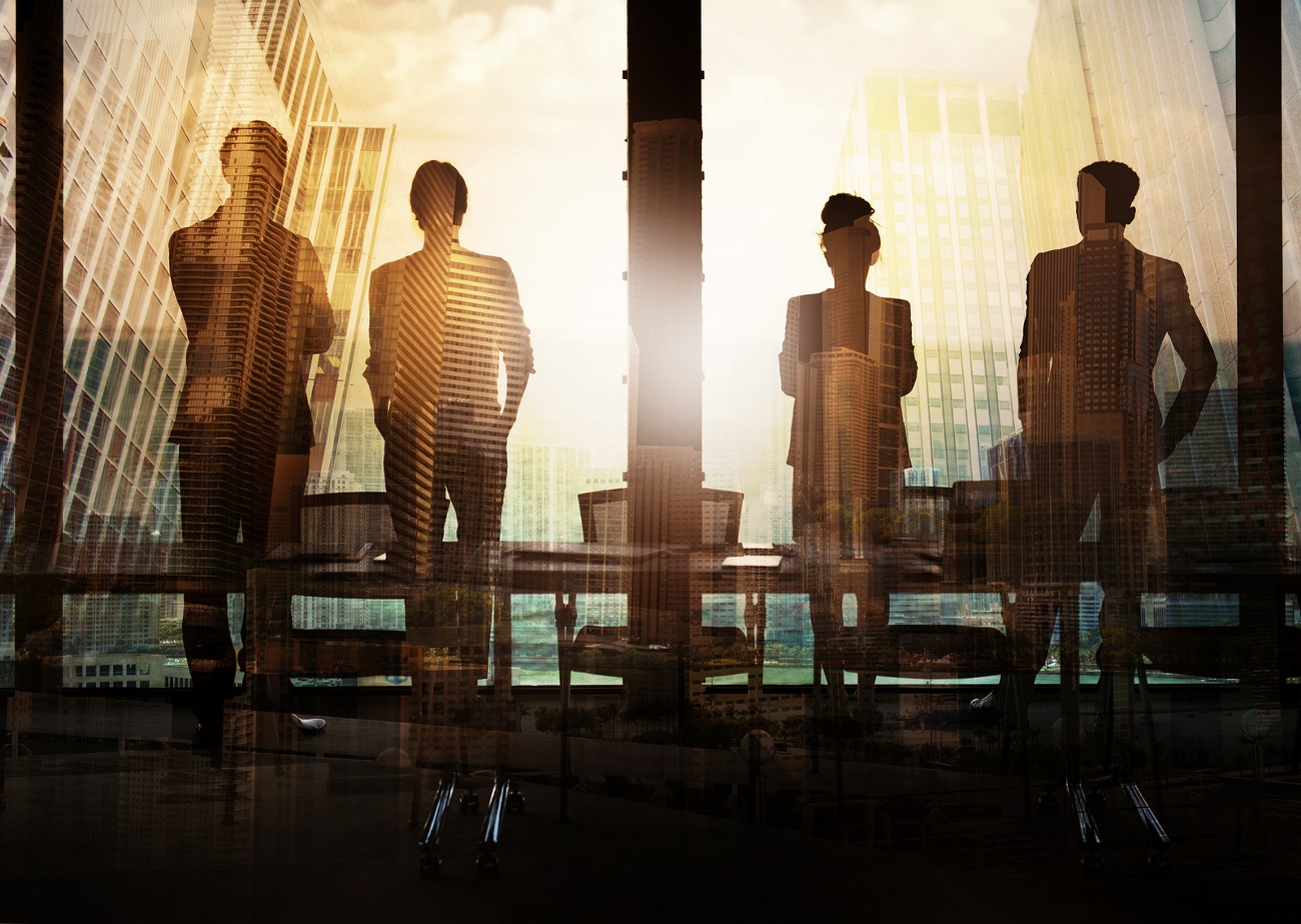 Four semi-translucent people stare out a  big window in an office